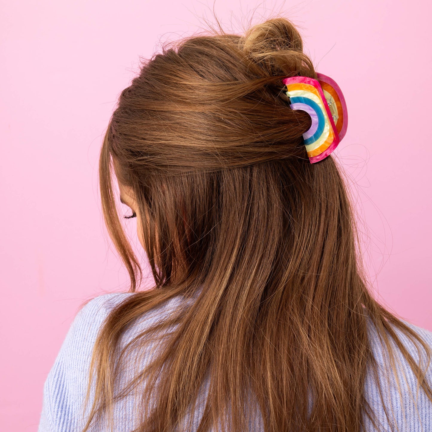 Colorful rainbow hair clip on a woman’s hair