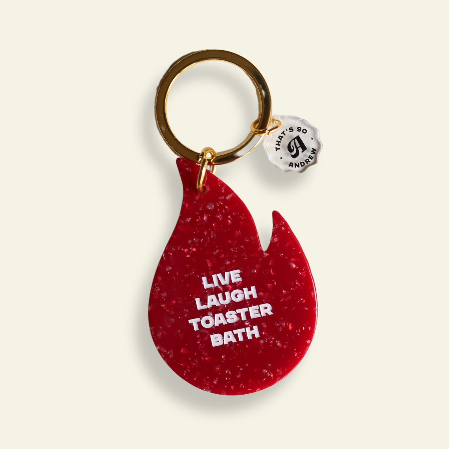 Red flame-shaped keychain with text