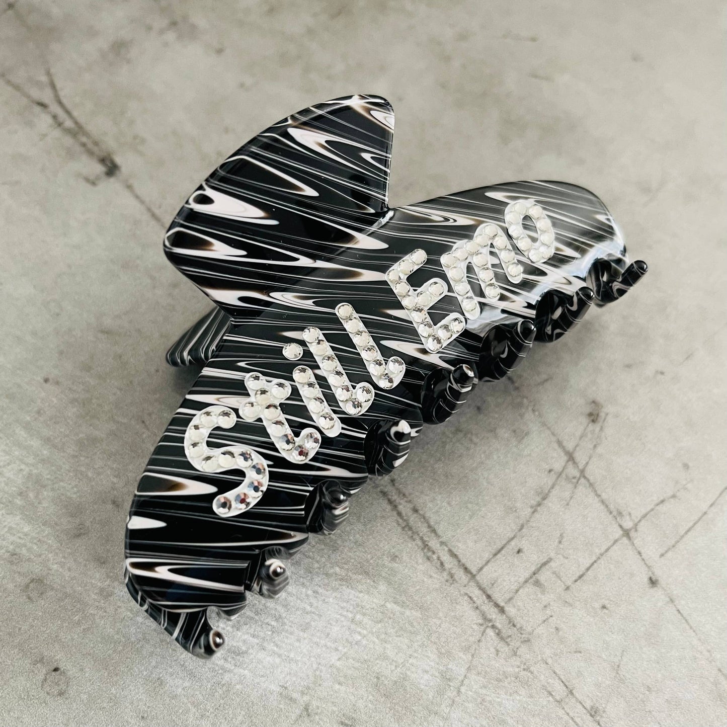 Stylish black and white hair clip with rhinestones