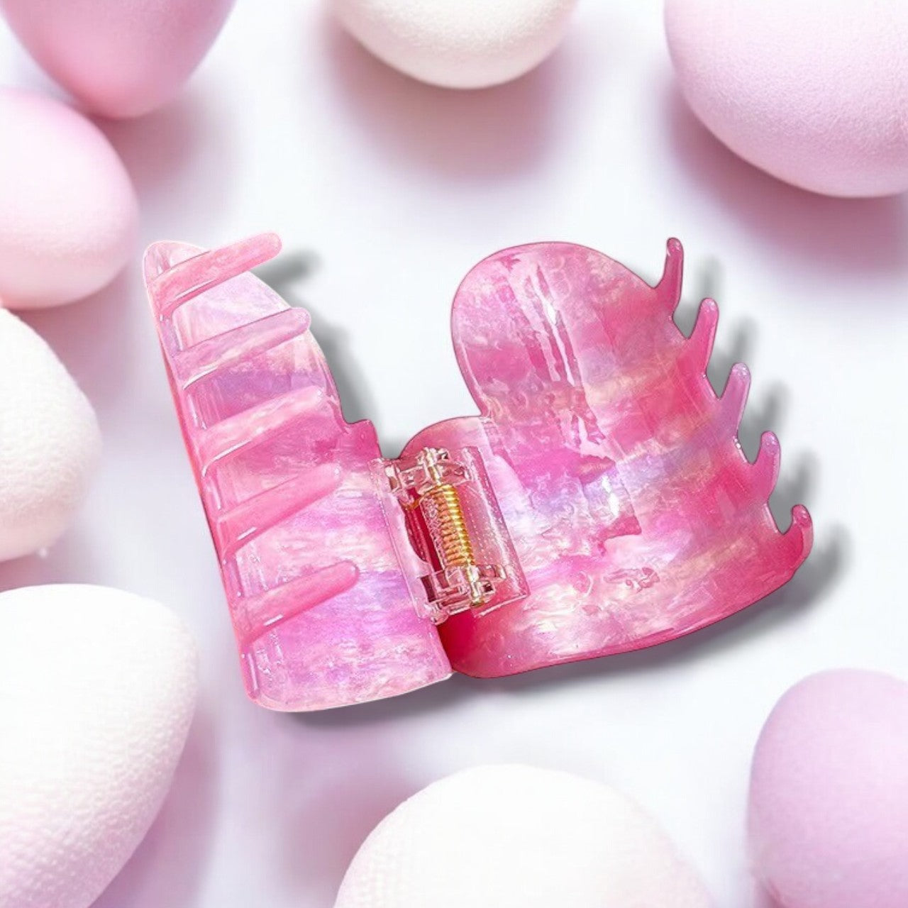 A stylish pink hair clip on a white background.