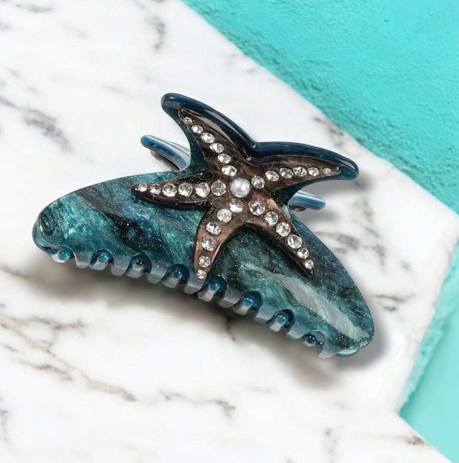 Teal starfish hair clip with sparkling crystals.