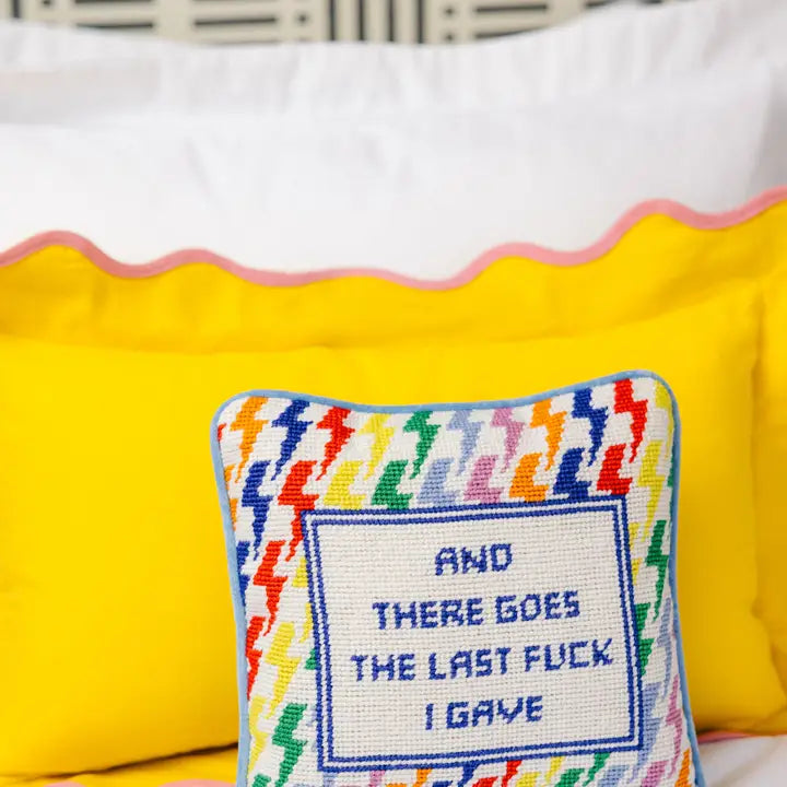 Humorous needlepoint pillow with the quote "There Goes My Last F*ck," featuring vibrant colors and soft backing.