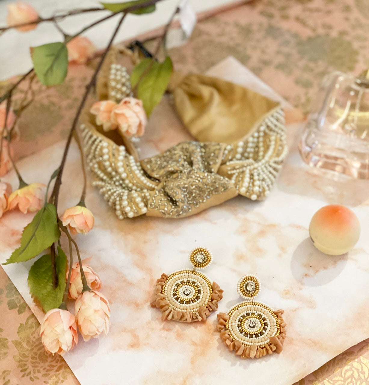 Lifestyle image of Andromeda Champagne Earrings displayed with elegant accessories.