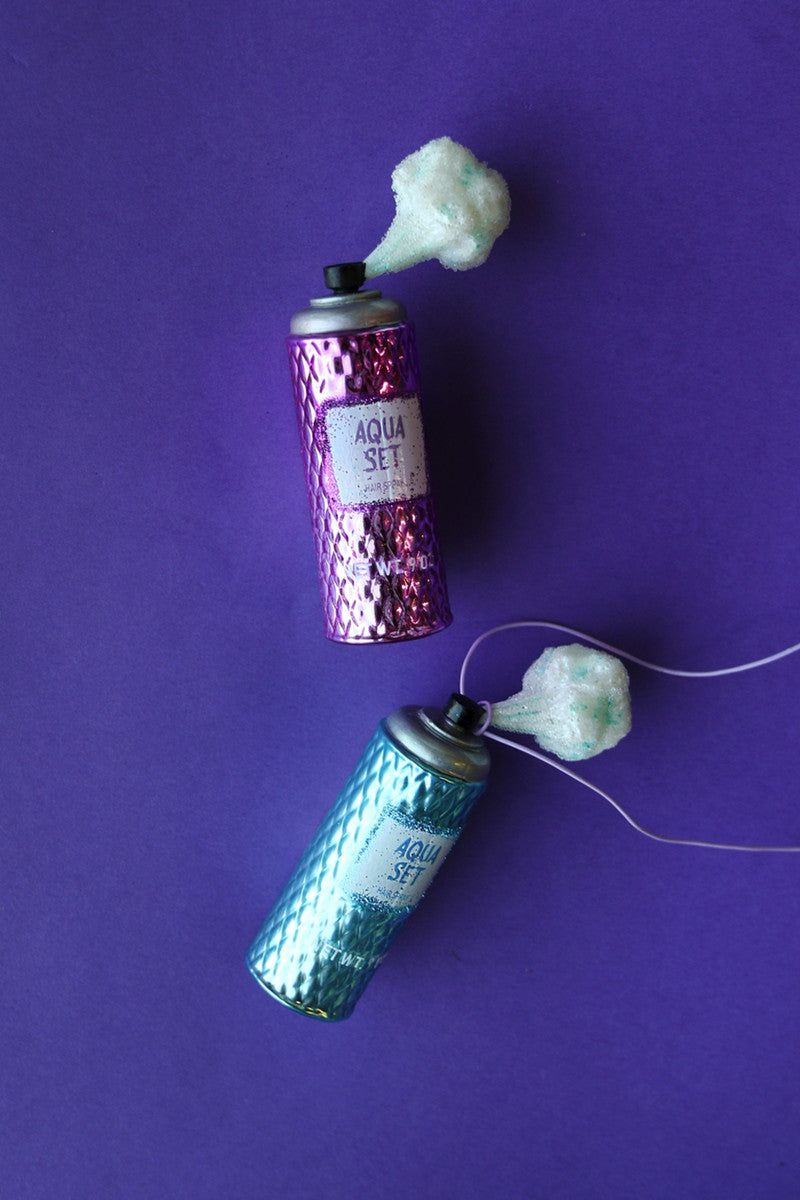 Glittery Christmas ornaments designed like vintage hairspray bottles, bringing fun and flair to your holiday decor.