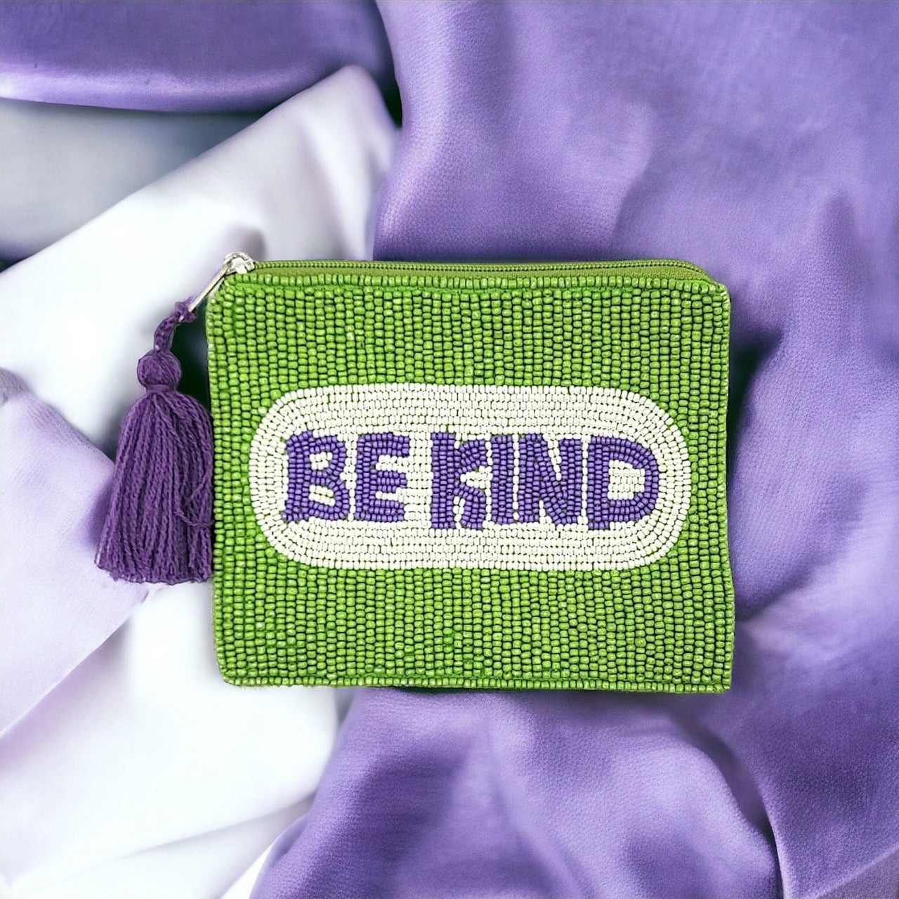 Green beaded pouch featuring "Be Kind" message with tassel detail, ideal for spreading positivity and style.