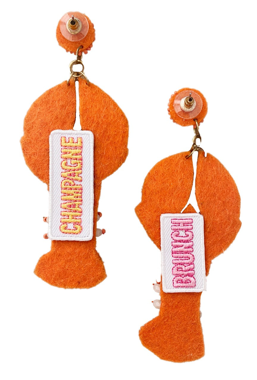 Hypoallergenic clip-on earrings featuring a lobster shape and bedazzled details.