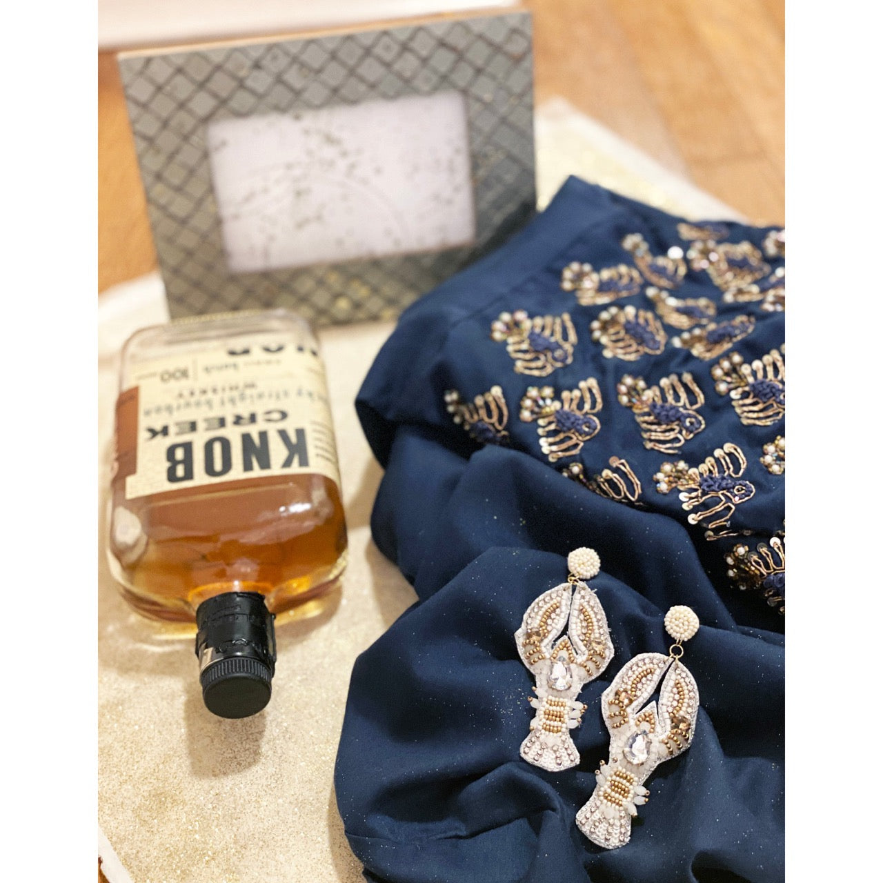 Glamorous hand-crafted earrings with a lobster motif and rhinestone accents.