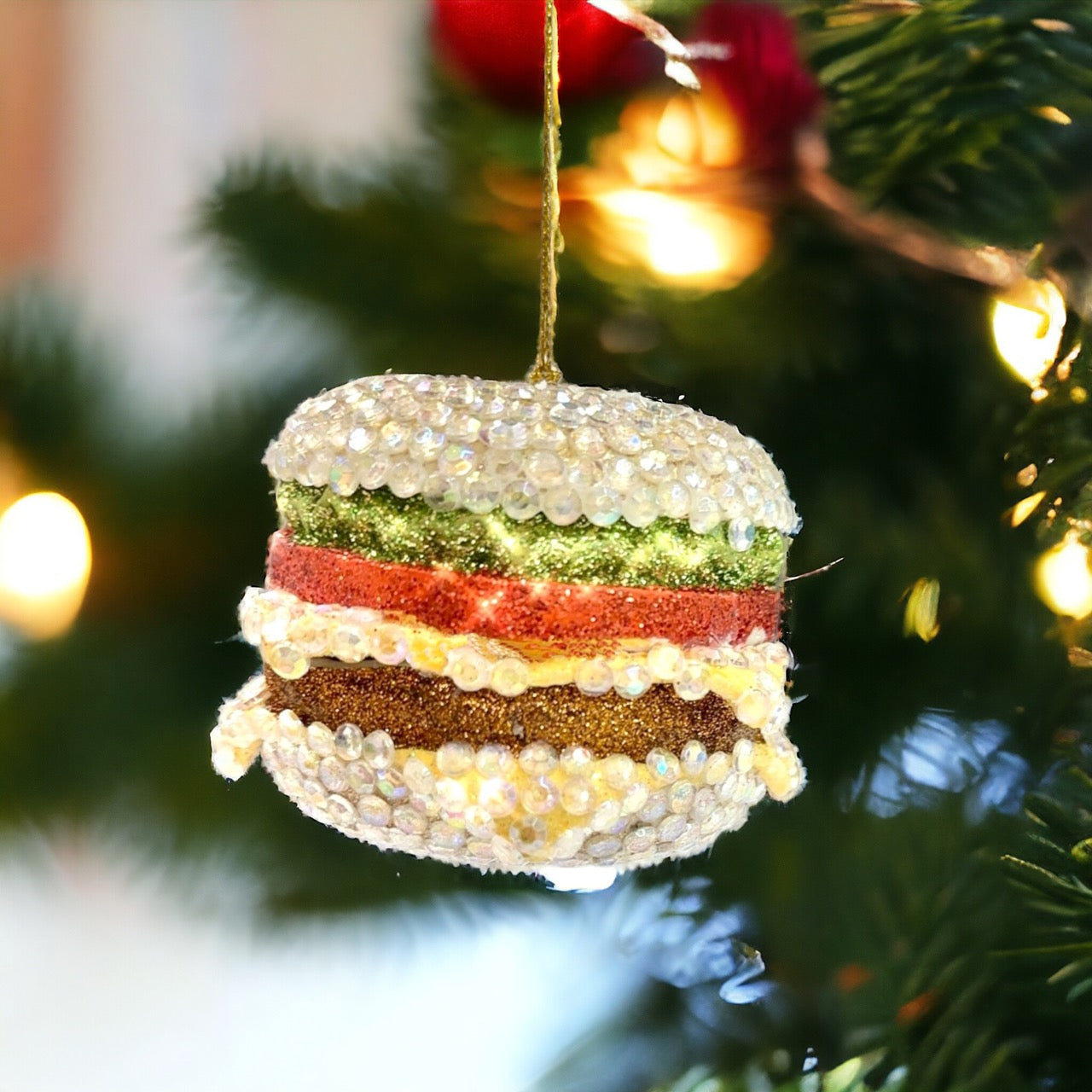Sparkling bejeweled cheeseburger ornament made from durable glass, perfect for quirky and glamorous holiday decoration.