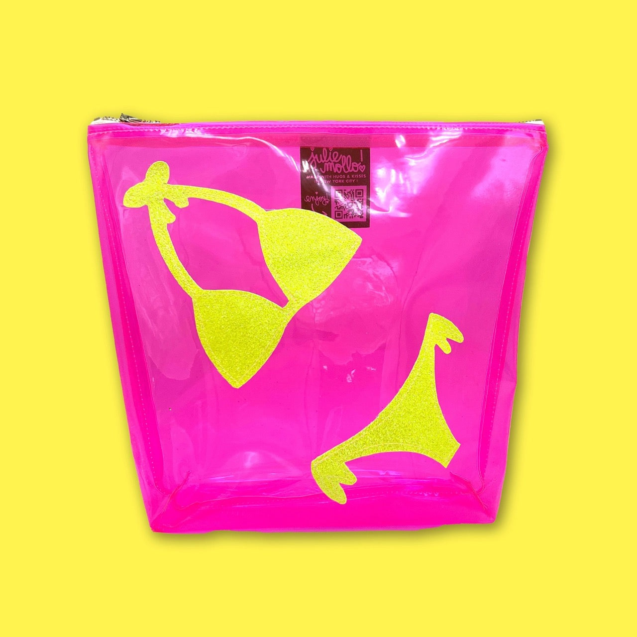 Hot pink clear pouch with neon yellow glitter bikini graphic, photographed on a bright yellow background.
