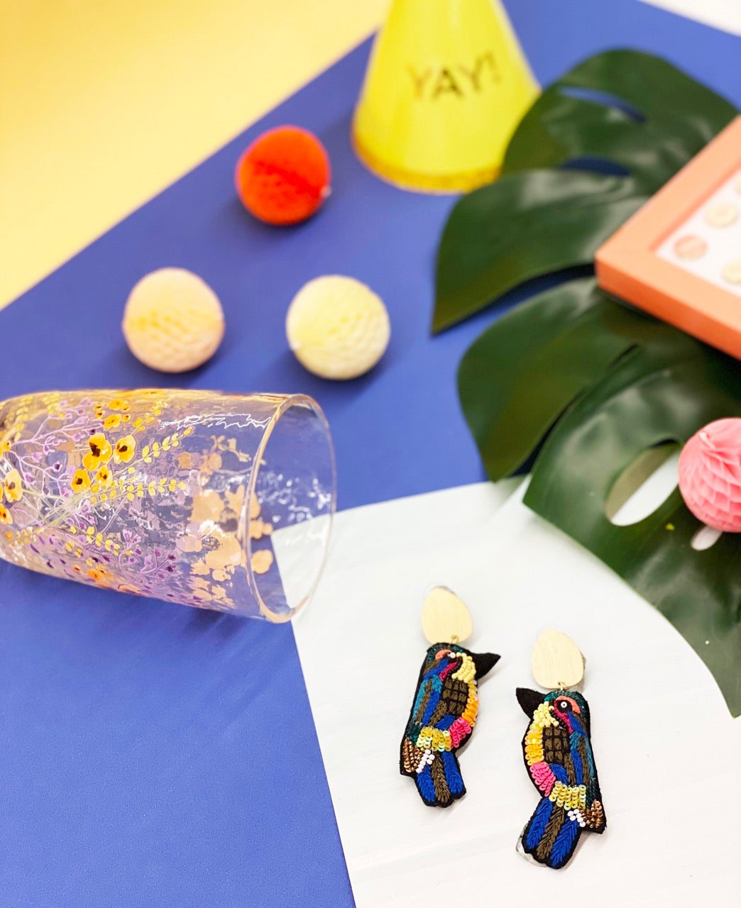 Lightweight handmade bird earrings with rainbow sequin feathers and hypoallergenic materials.