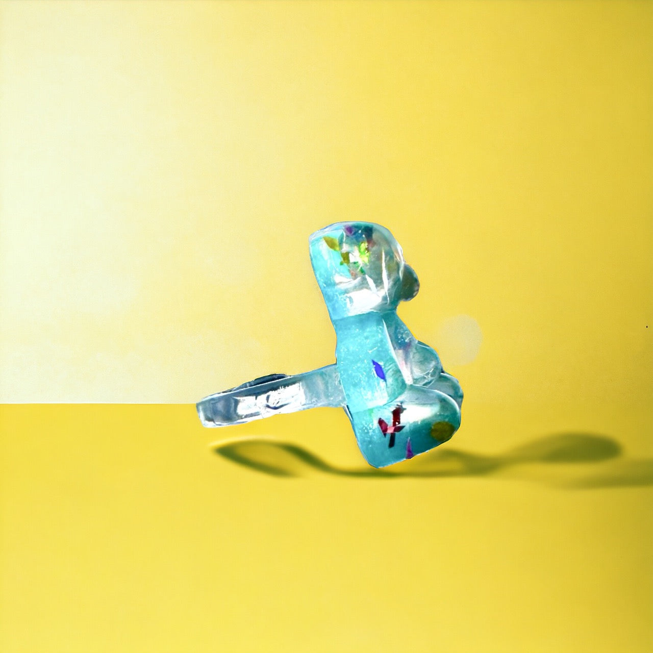 Vibrant blue gummy bear ring with playful confetti detailing, a unique and stylish accessory.