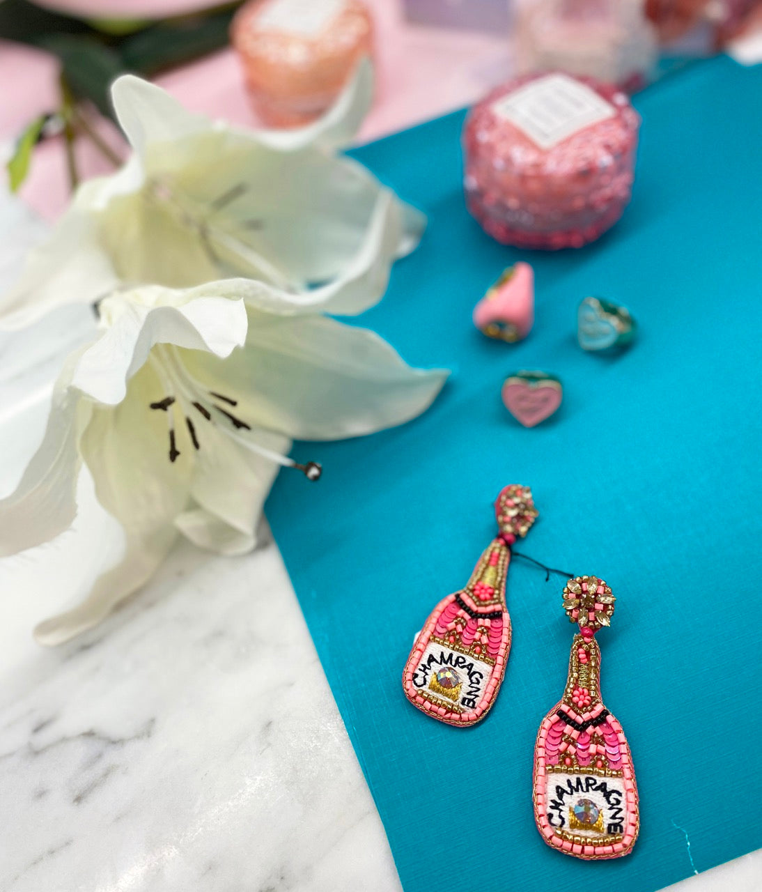 Fashion earrings with champagne bottle design and "Hell Yeah!" patch.