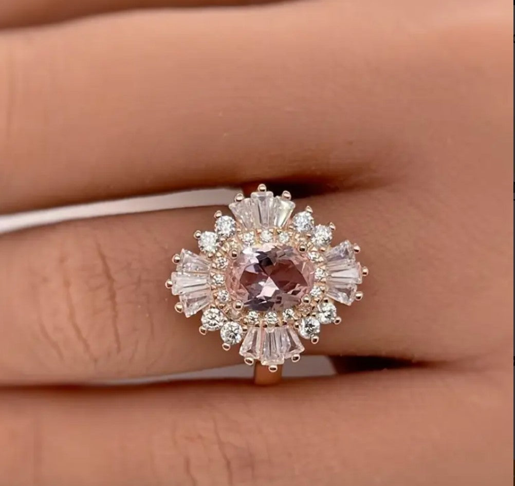 Close-up of rose gold floral ring on finger