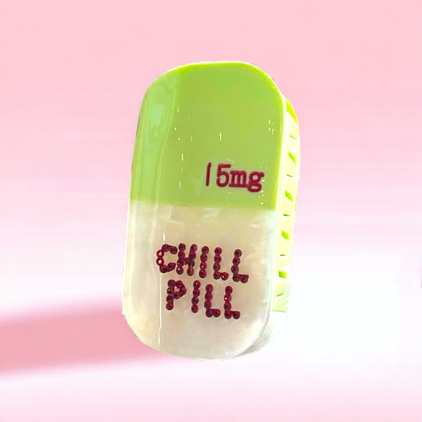 Unique and eye-catching green hair clip with a chill pill charm, ideal for those who embrace a carefree style.