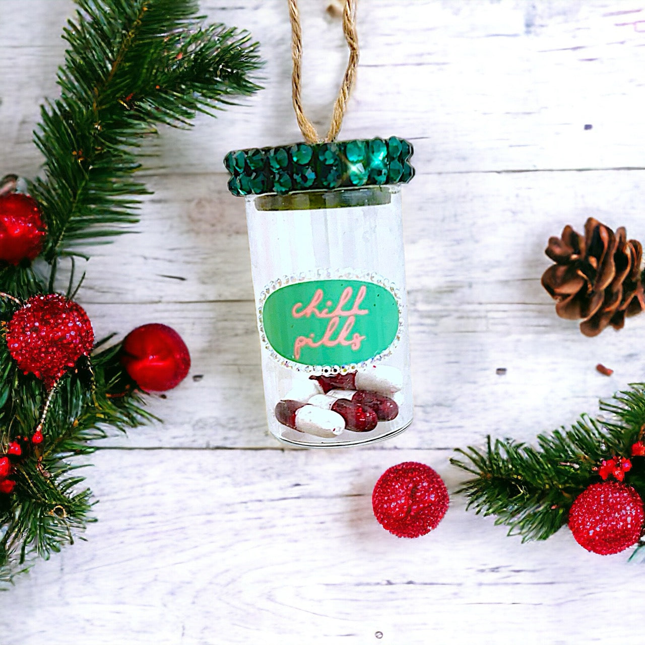 Fun and whimsical glass ornament labeled "Chill Pills," perfect for adding a humorous touch to your holiday decorations.