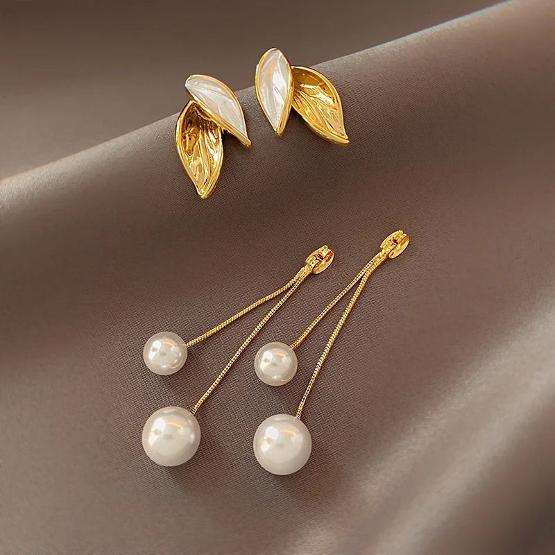 Stunning pearl drop earrings, crafted with genuine cultured pearls, offering a touch of timeless luxury to elevate your style.