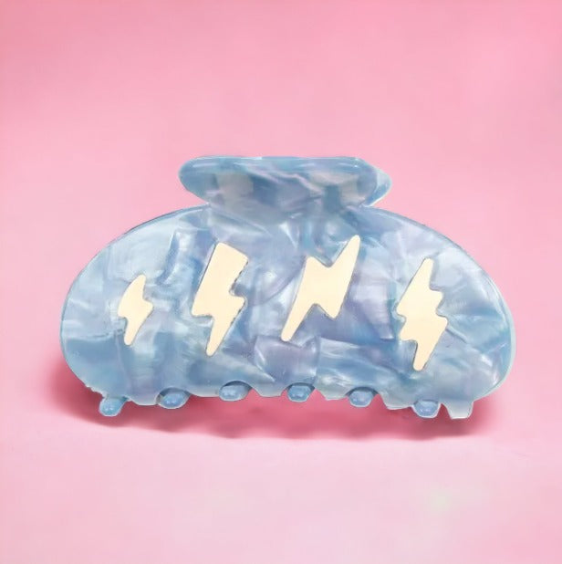 Cute blue hair clip with white thunderbolt design.
