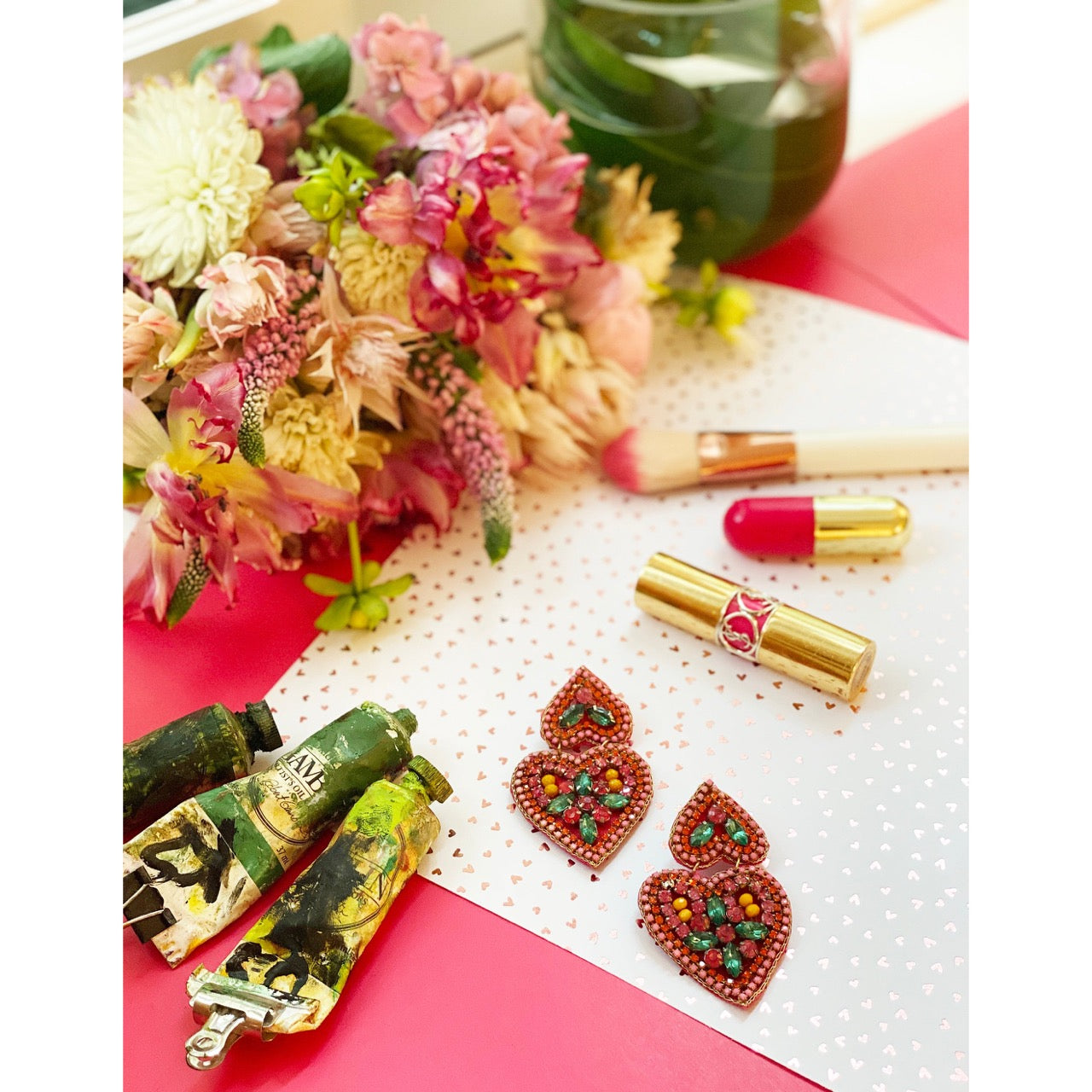Pink statement earrings with heart shapes and multicolor beading, great for adding joy to your wardrobe.