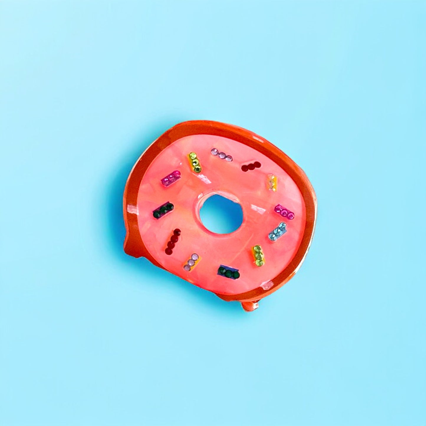 Eye-catching donut hair clip in baby pink, a versatile accessory for both casual and formal occasions.