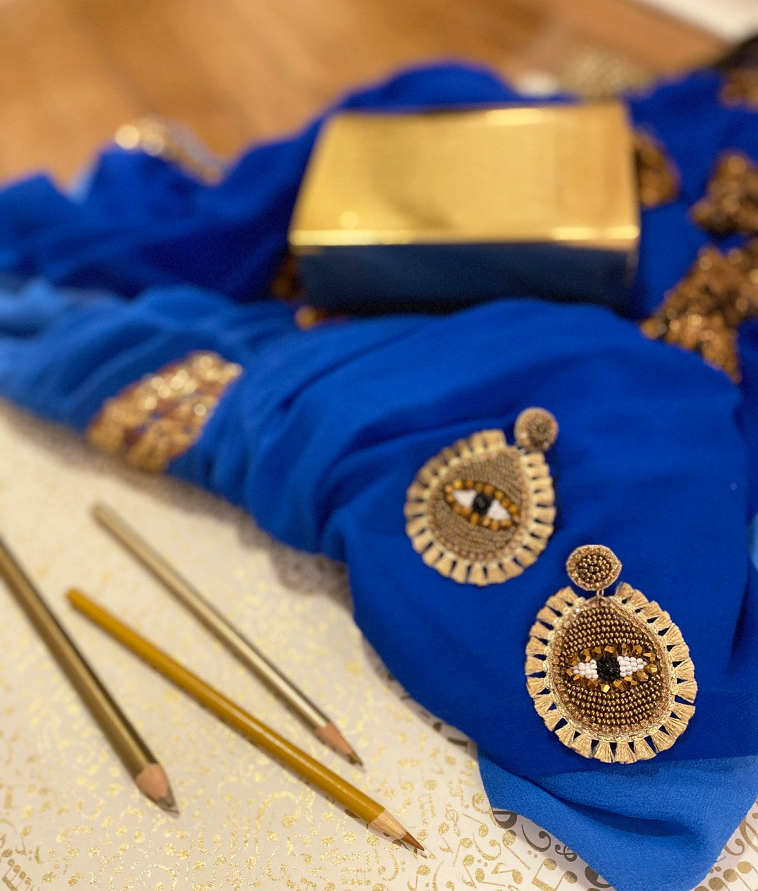 Artistic handcrafted gold tassel earrings with hypoallergenic design.