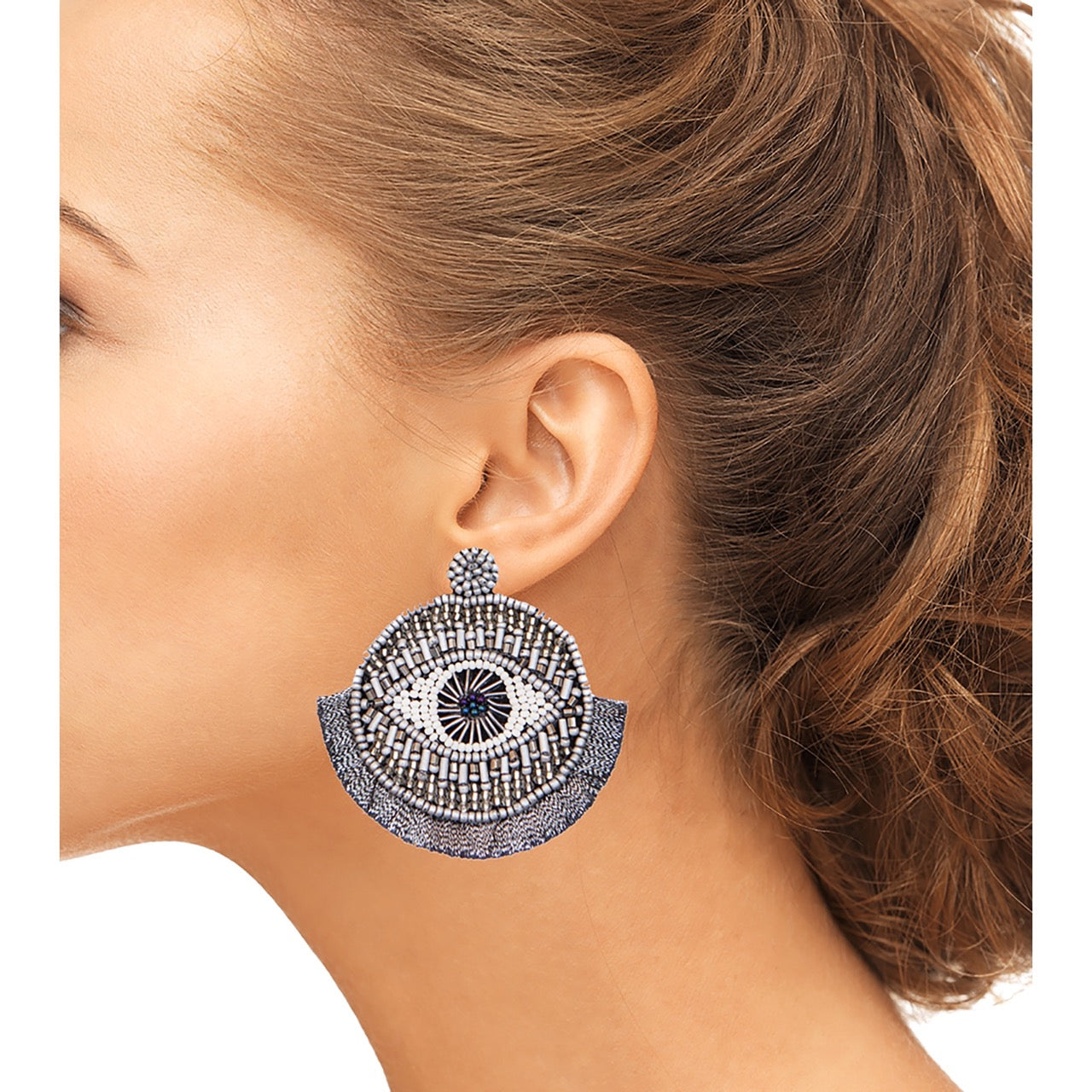 Pair of eye catcher silver earrings against a white background, emphasizing their unique and stylish design.