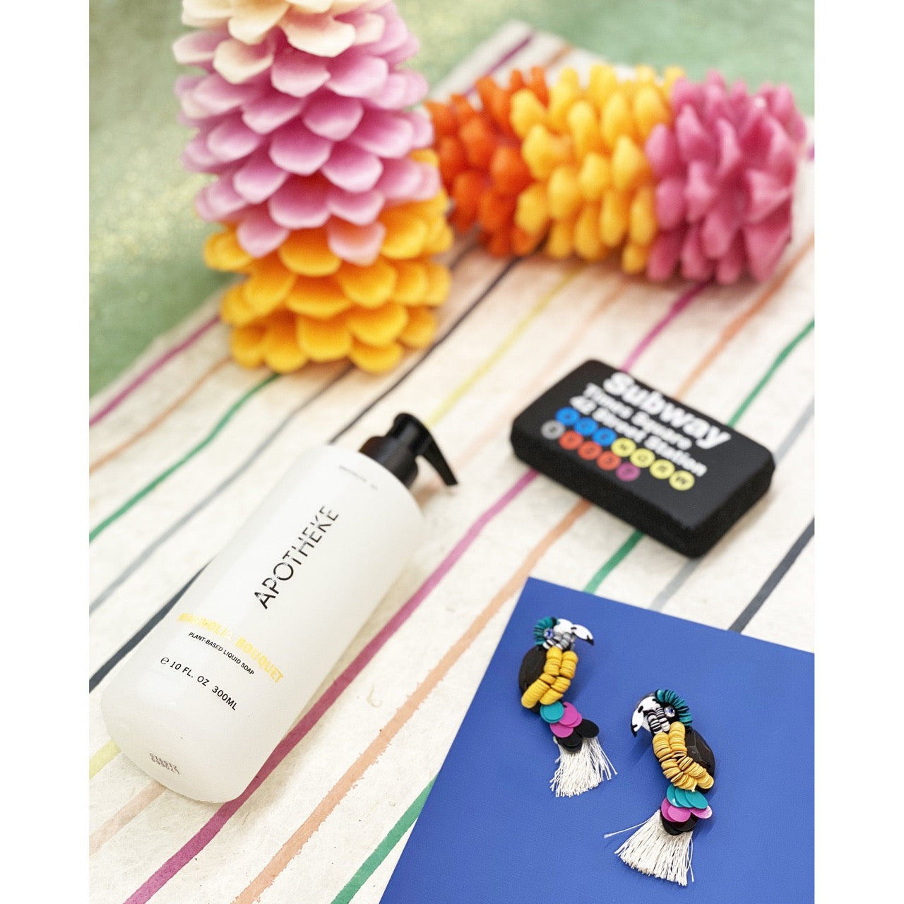 Handcrafted ivory earrings with playful parrot design, colorful discs, and fringe tail, perfect for stylish outings.