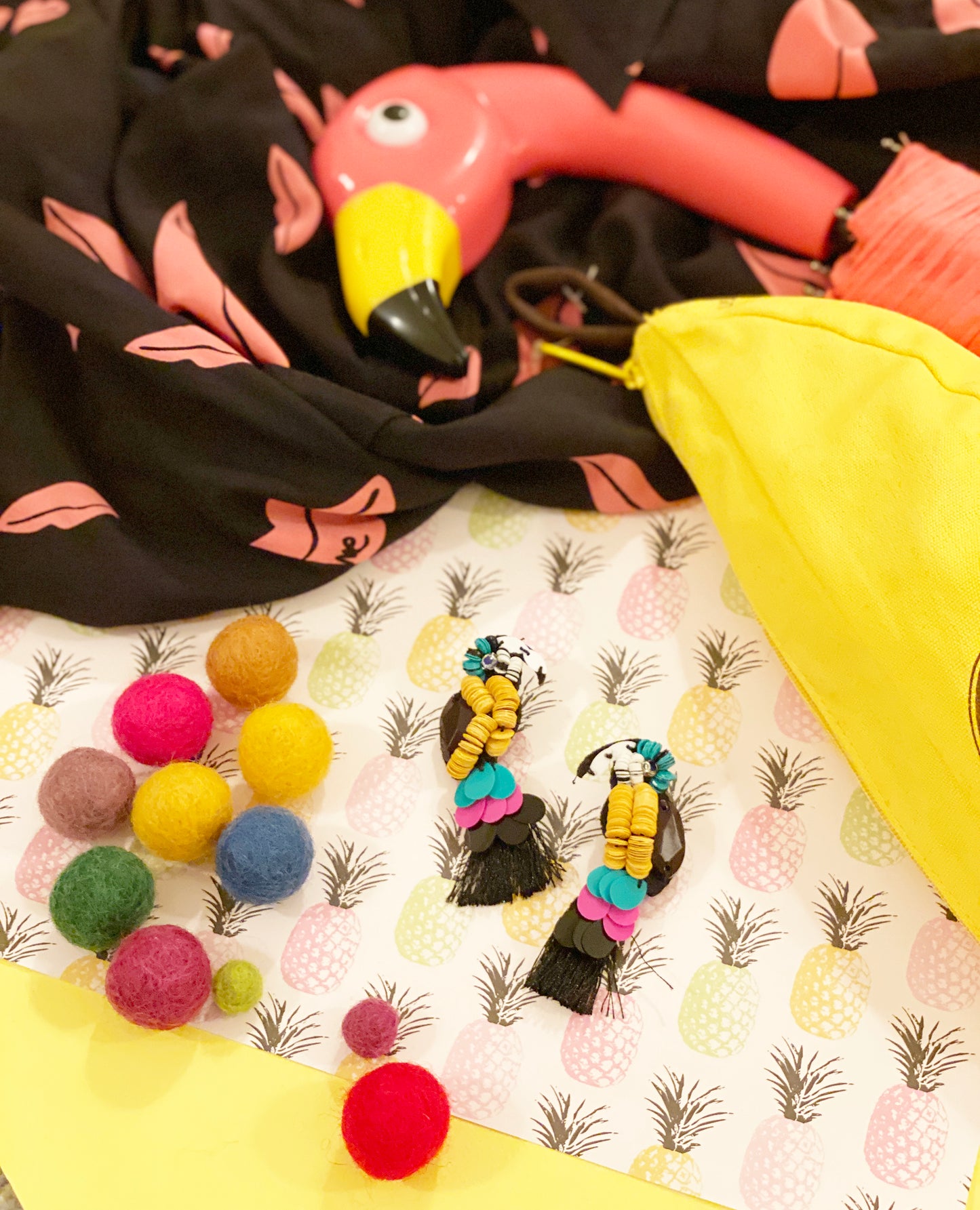 Stylish parrot earrings with tropical sequins and black tassels, perfect for adding a touch of summer to your look.