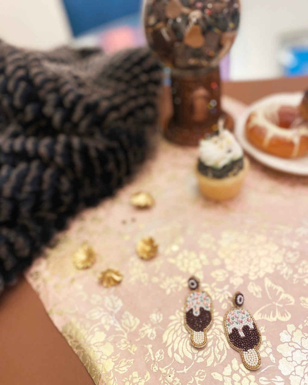 udgesicle-themed earrings with a whimsical design, featuring intricate beadwork and a chocolate sprinkle motif.