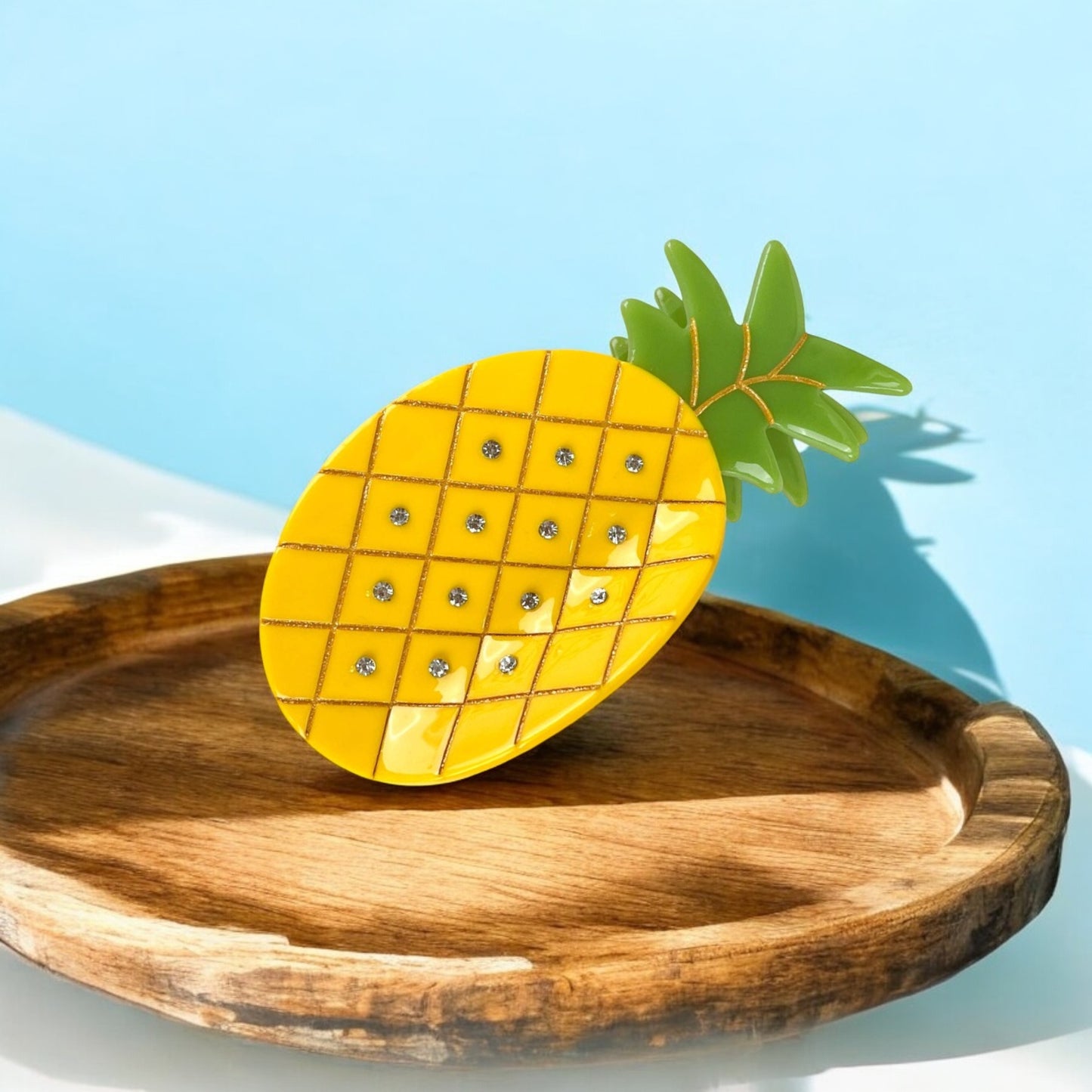 Pineapple hair clip with bright yellow base and green leaves, perfect for thick hair and tropical styles.