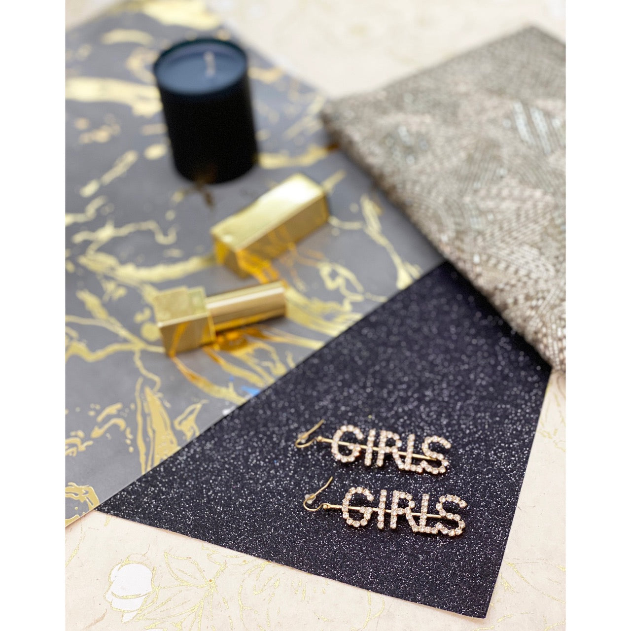 Empowering gold earrings with rhinestone-studded GIRLS letters for bold fashion