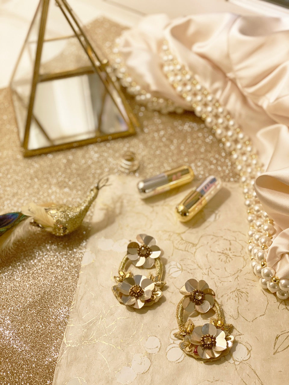 Elegant gold earrings with unique patch design, combining style and whimsy.