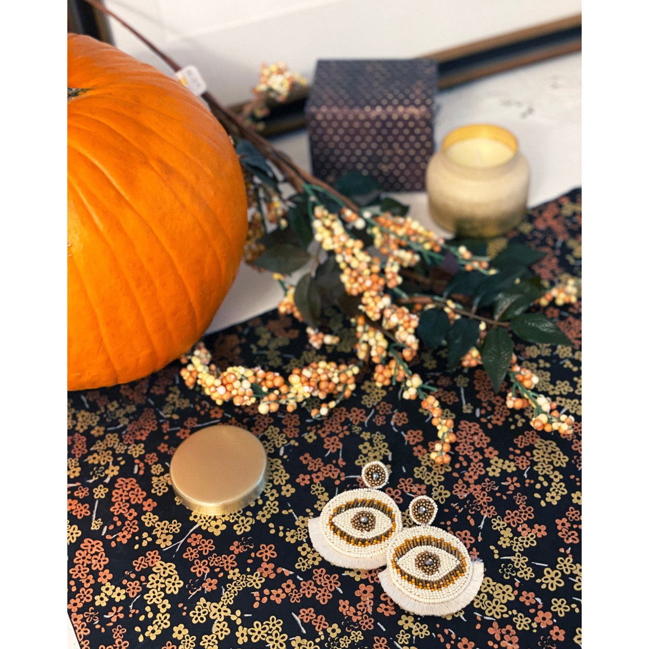 Statement fringe earrings with gold and black beaded eyes and artistic style