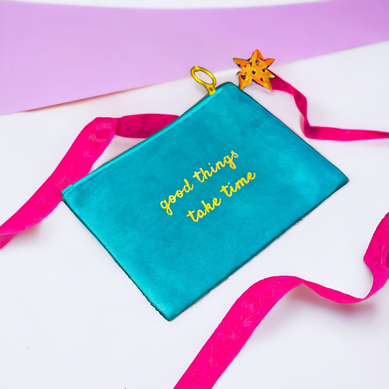Stylish suede pouch featuring the inspirational quote "Good things take time" in gold lettering. Perfect for organizing essentials with a touch of motivation.