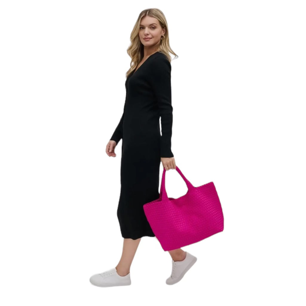 Large pink tote with a basketweave texture, ideal for carrying essentials for beach trips or everyday use.