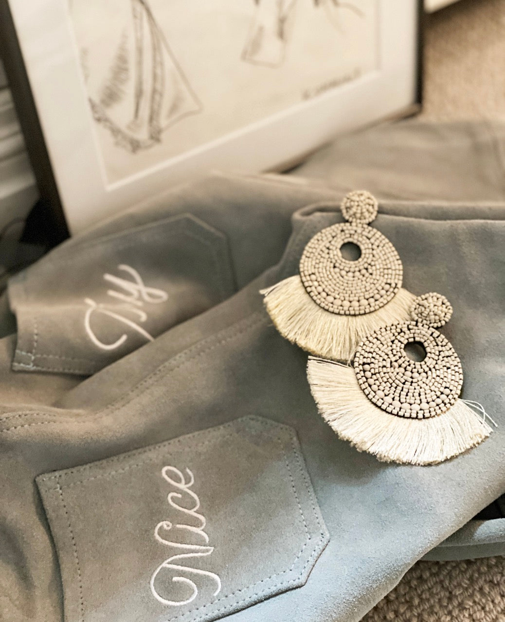 Handcrafted ivory fringe earrings featuring a unique chill pill patch.