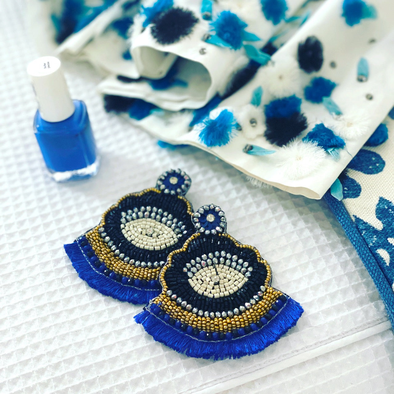 Trendy Los Cabos Blue Earrings with blue beaded tassels and "Cosmic AF" patch, handcrafted and hypoallergenic.
