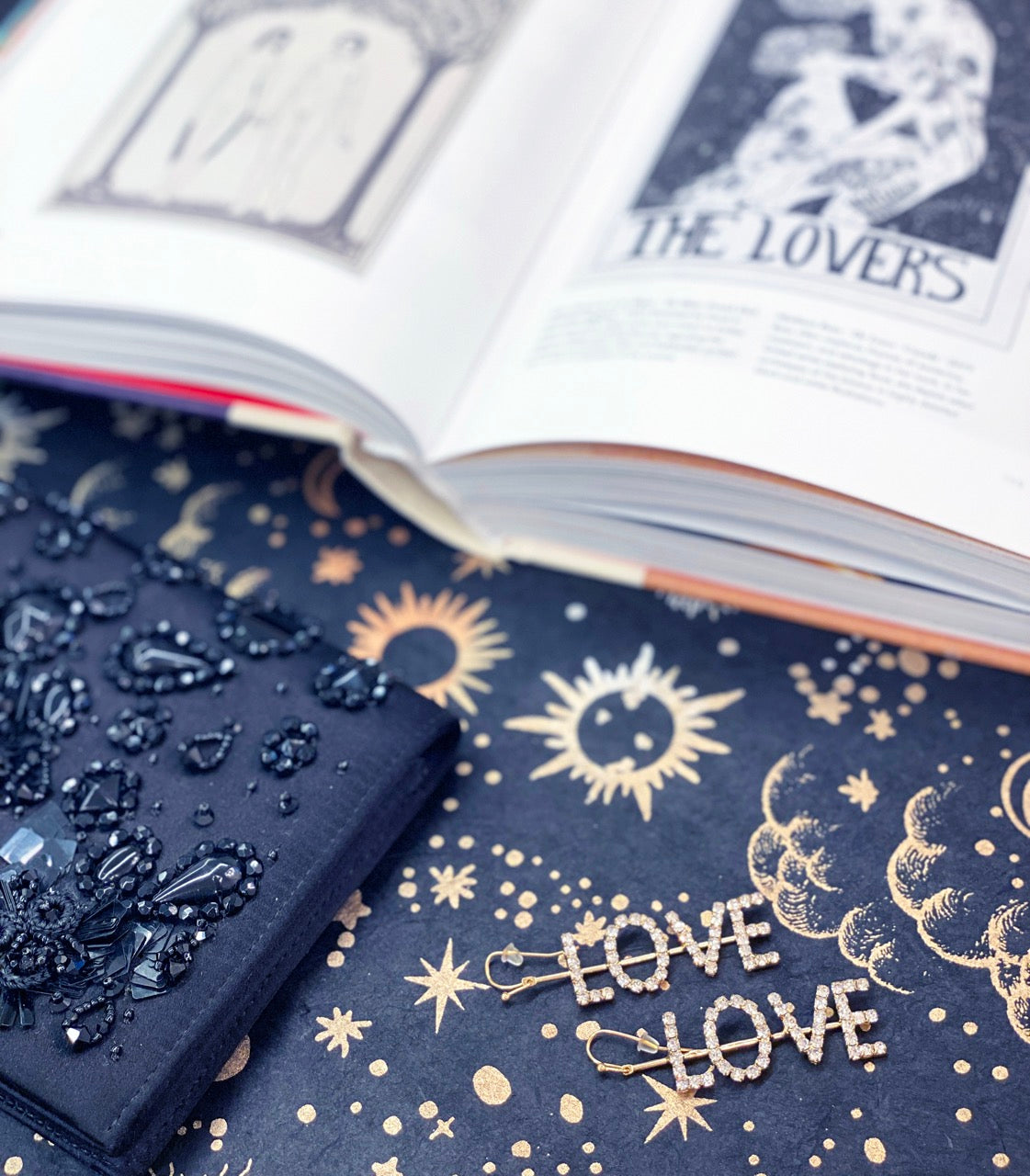 Vertical word earrings spelling LOVE in crystal rhinestones on gold drop hooks