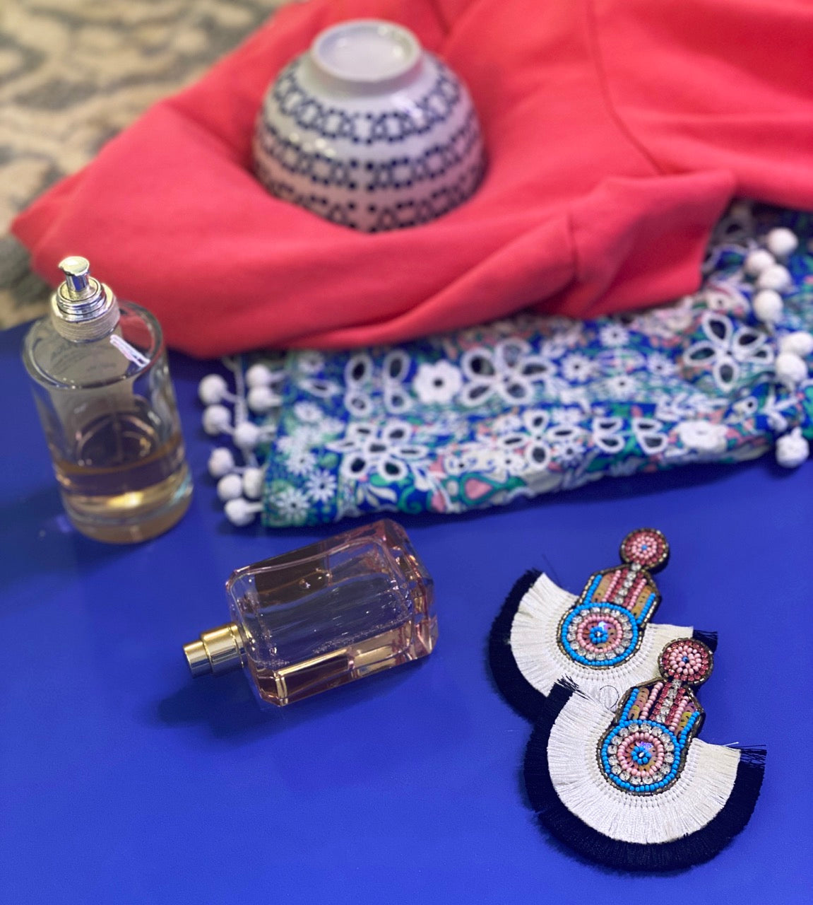 Fashion-forward earrings with intricate beadwork in soft hues, navy and white fringed fans, and pink popsicle embellishments on felt backs.