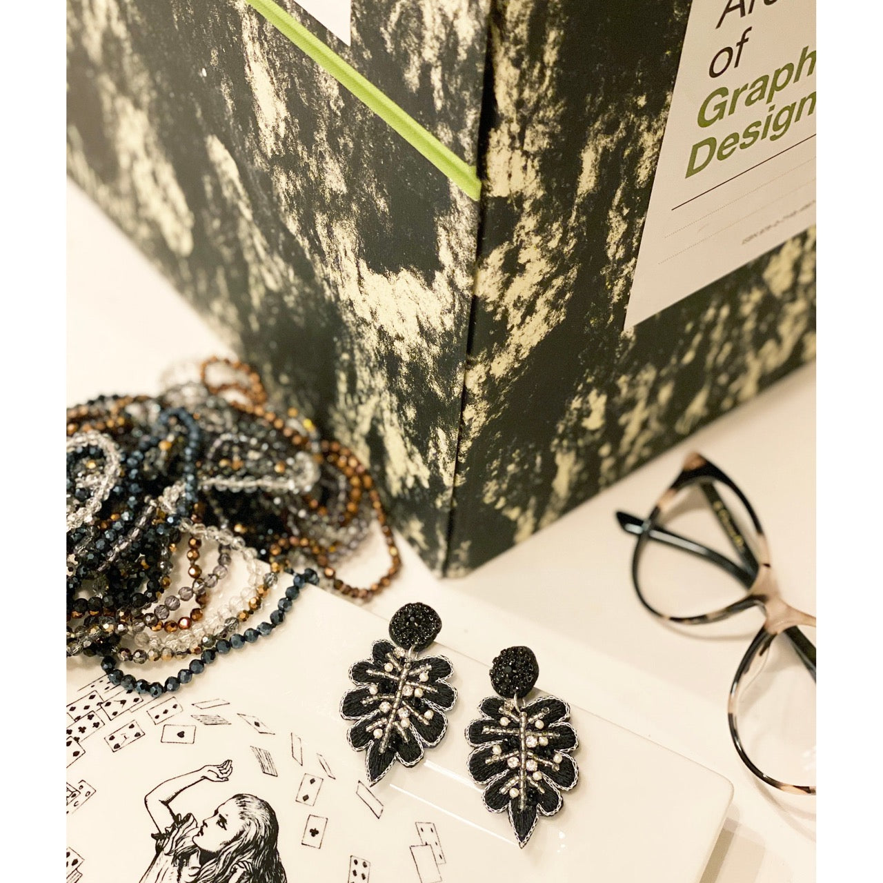 Unique silver leaf earrings with Buddha patch design, perfect for any fashionista.