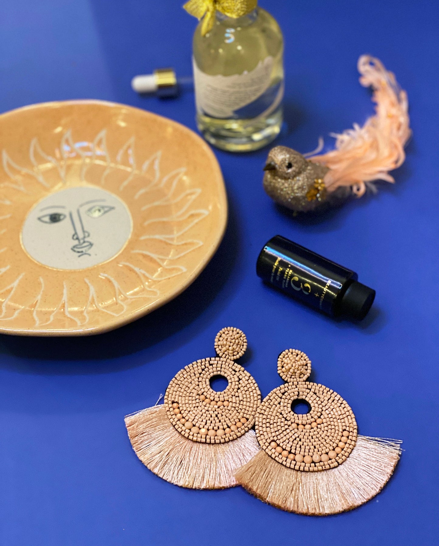 Seascape-inspired nude earrings with double fan fringe and intricate beadwork.