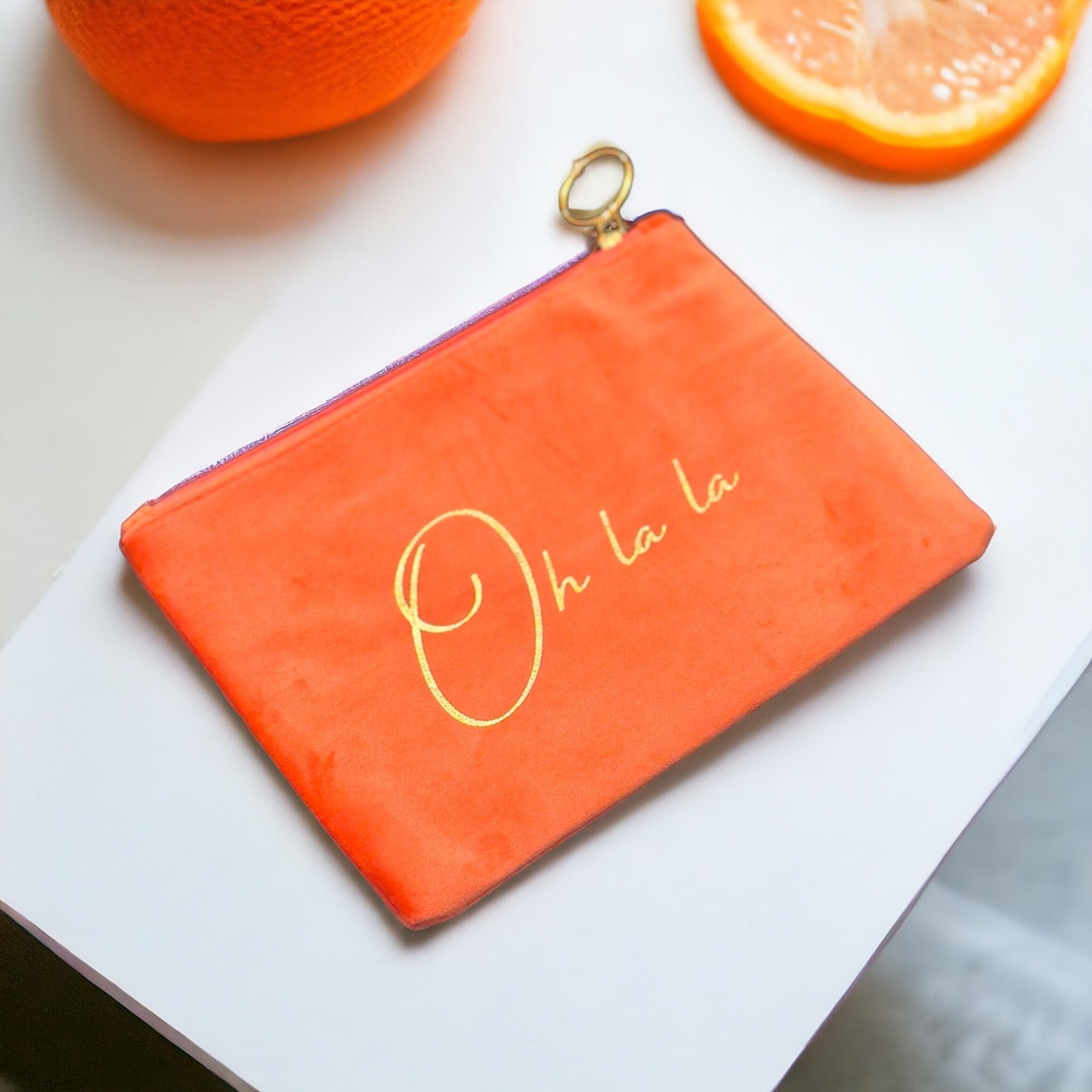 Soft and alluring turquoise suede pouch with golden zipper accent, ideal for storing cosmetics or jewelry.