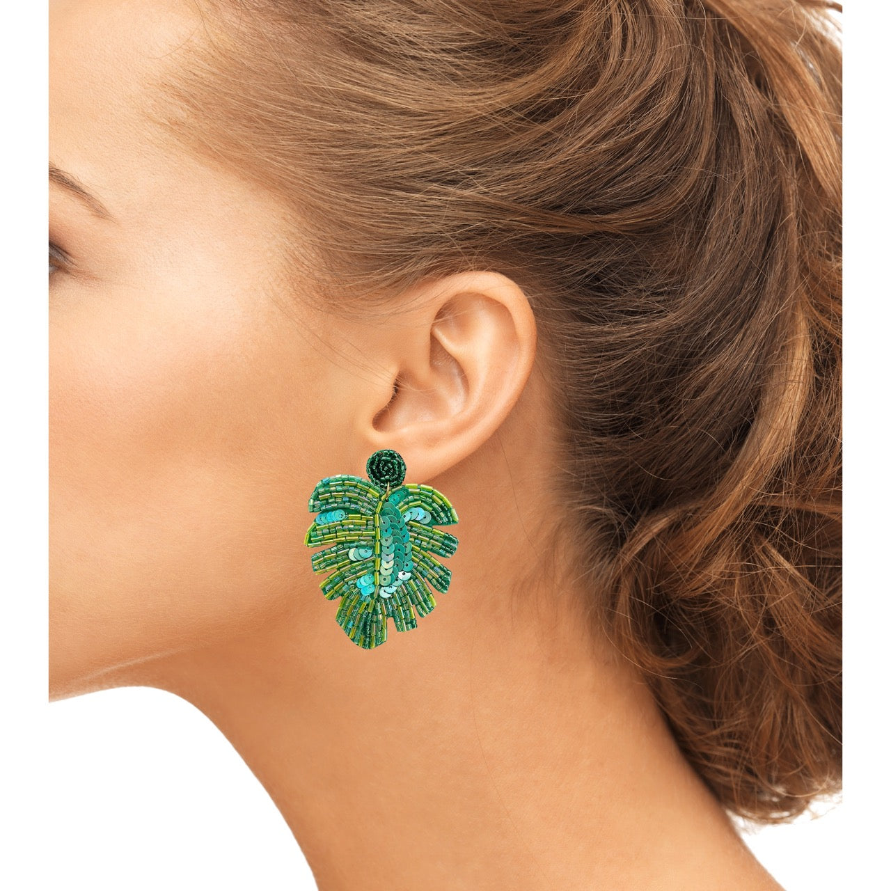 Whimsical palm leaf earrings with green beading and empowering text patches, perfect for sensitive skin.