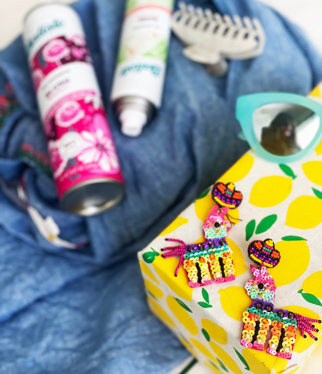 Statement earrings featuring glittery sequin llamas, bright sombreros, and red felt charms with bold "Love" and "More" text.
