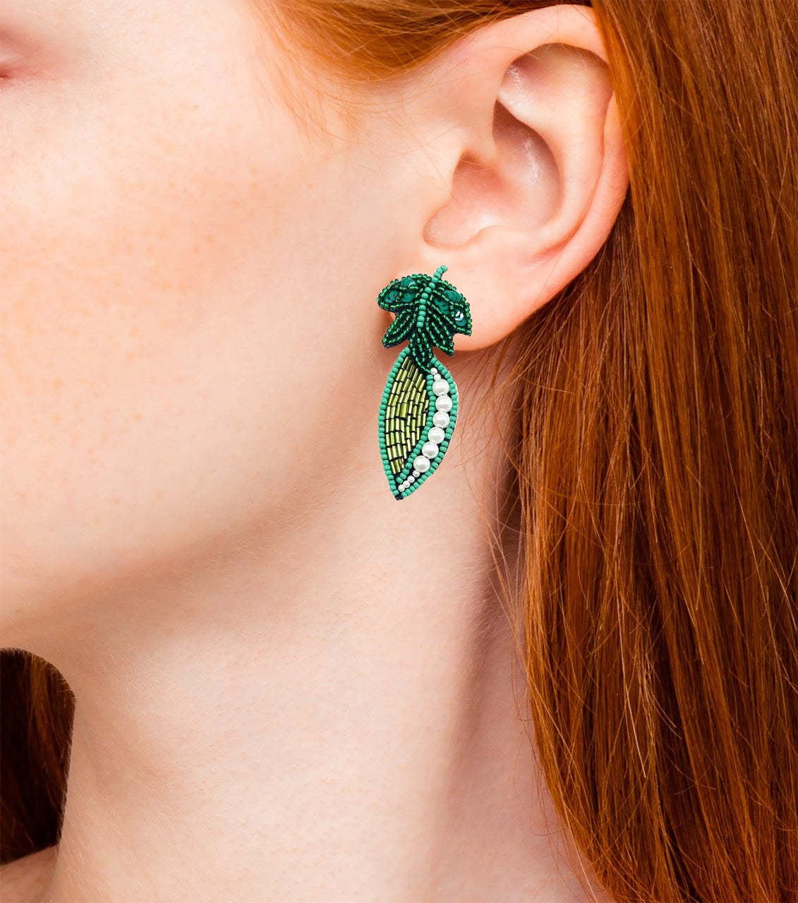 Unique pearl pod earrings with tropical leaf design and Cali Love patches.