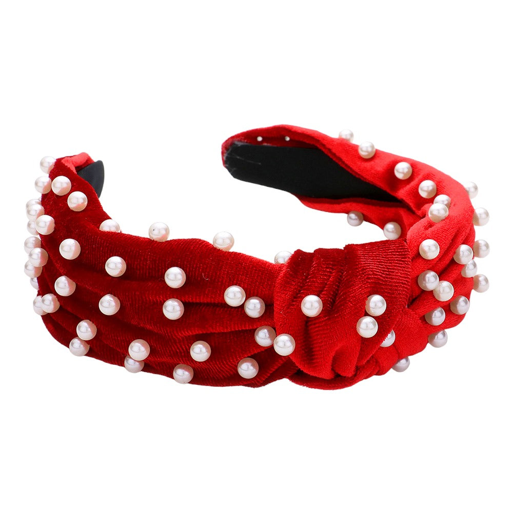 Pearl-embellished crimson headband, featuring luxurious pearls on a bold red background, perfect for making a stylish statement.