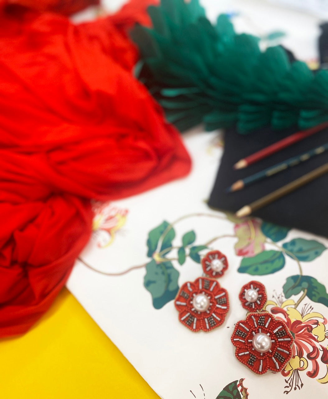 Statement red flower earrings with beaded detail, pearl centers, and embroidered kiss lips