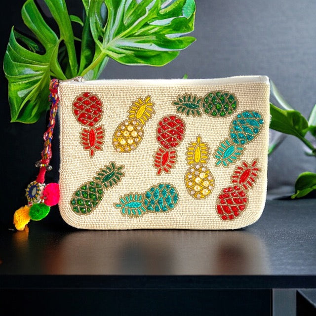 Unique pineapple-shaped cosmetic pouch featuring a colorful tropical design, ideal for storing makeup brushes, toiletries, or small accessories.