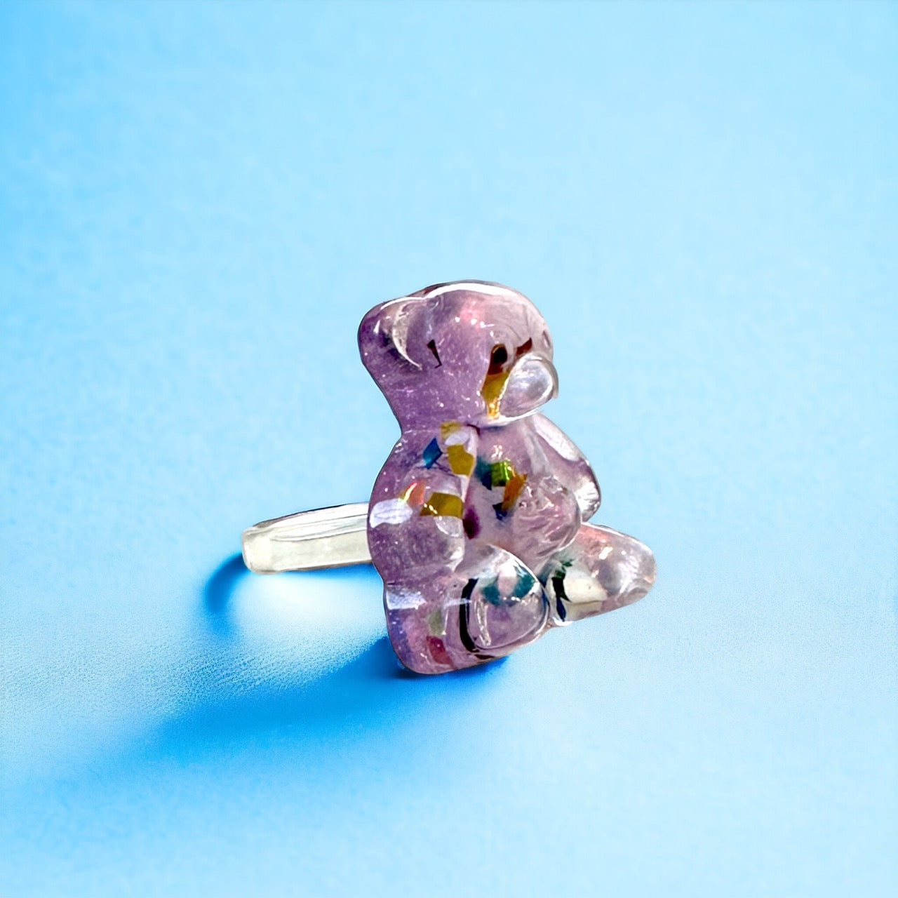 Vibrant pink gummy bear ring with playful confetti detailing, a unique and stylish accessory.