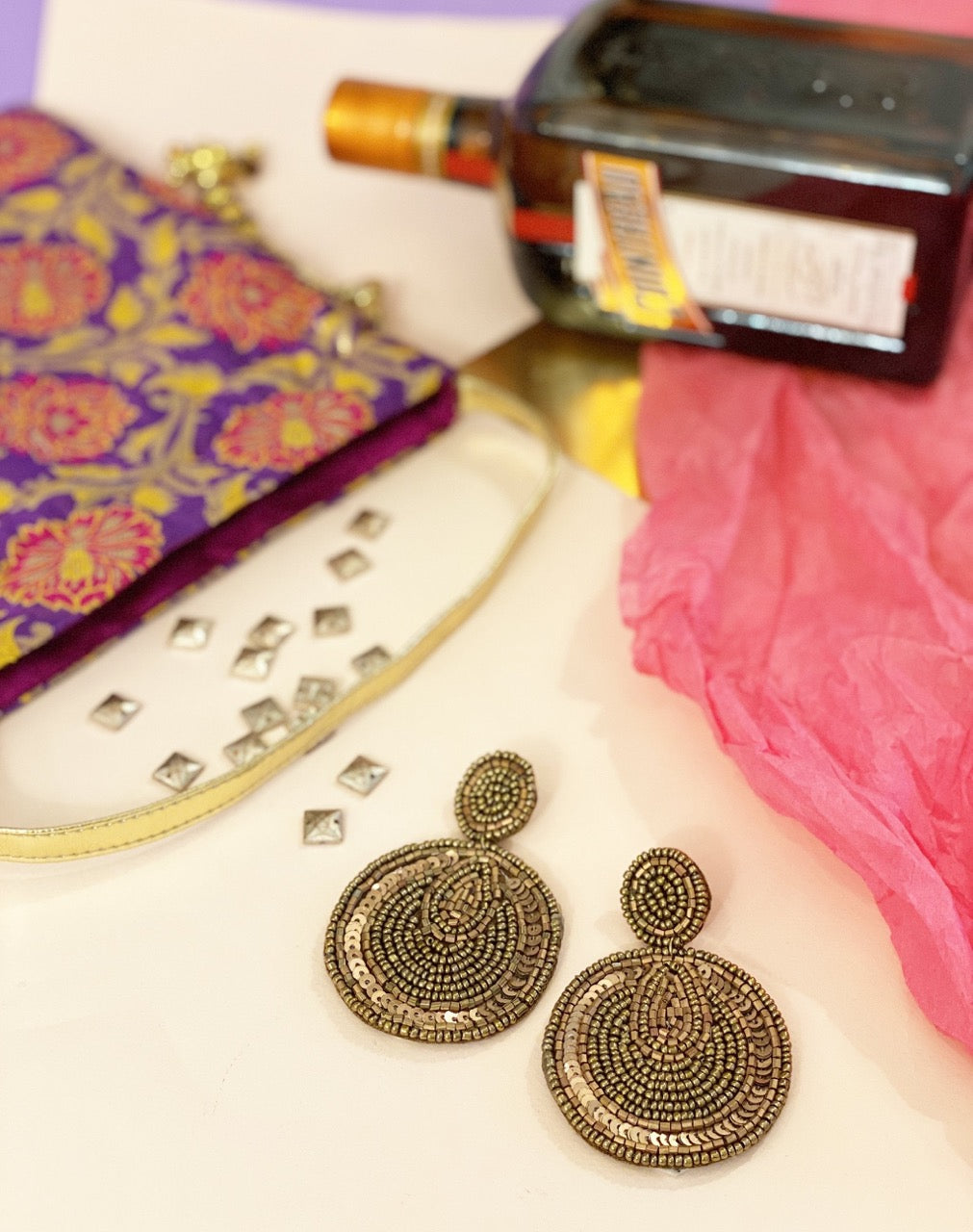 Opulent bronze beaded earrings showcased in a luxe setting, paired with vibrant accessories and a hint of celebration—perfect for adding glam to your festive wardrobe.