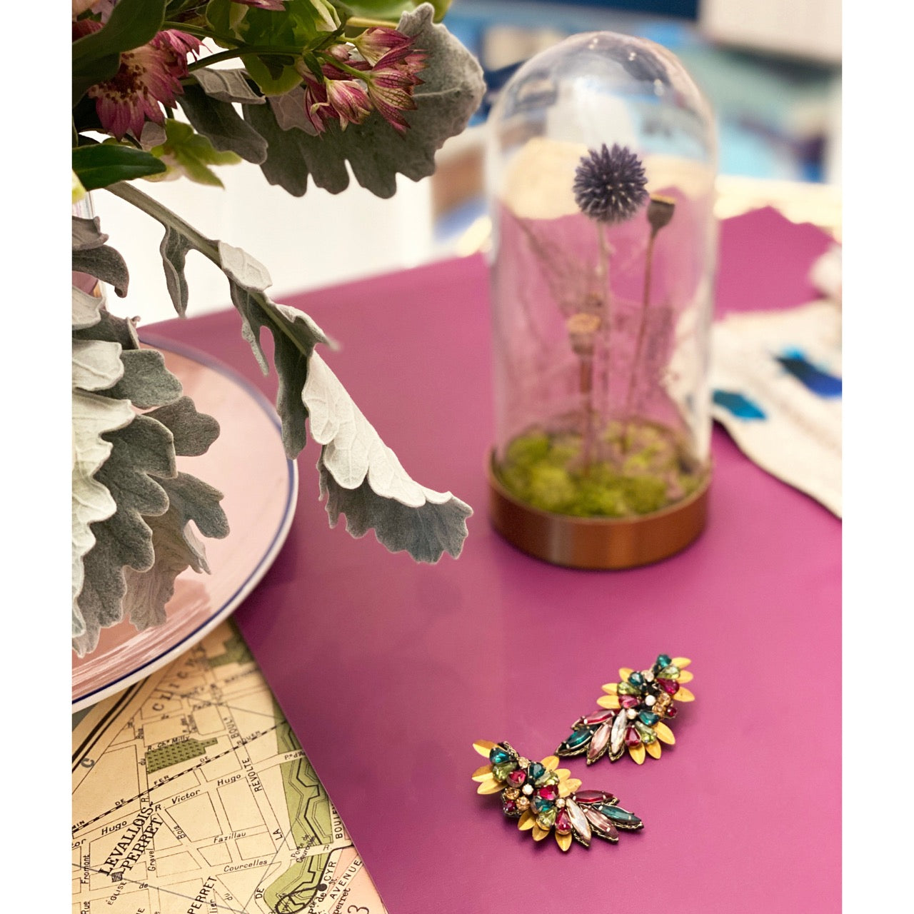 Statement earrings with layered rhinestones and surprise “Shit Happens” message on back